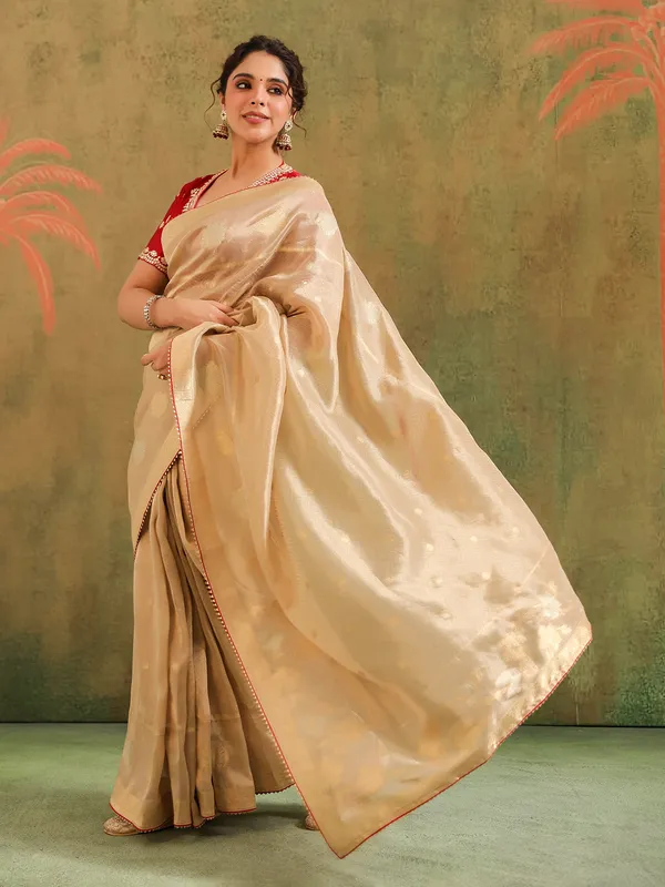 Beige zari worked silk saree with maroon blouse
