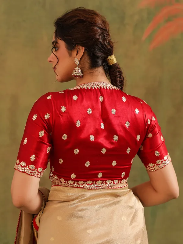 Beige zari worked silk saree with maroon blouse