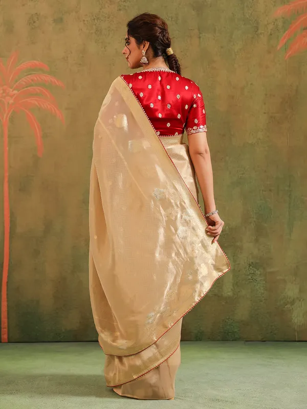 Beige zari worked silk saree with maroon blouse