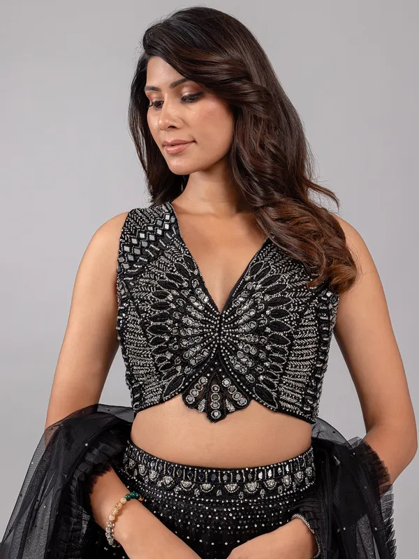 Black net lehenga choli with shimmering mirror accents