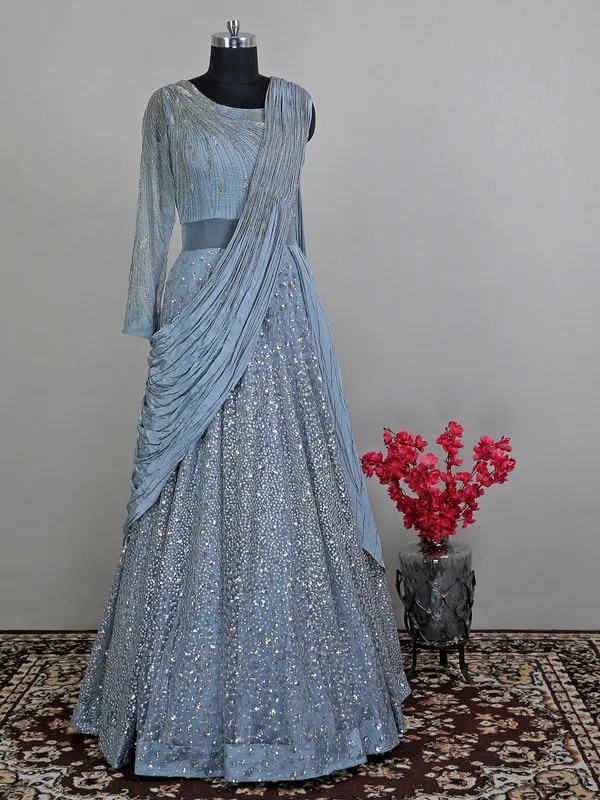 Blue net floor length gown with draped odhani pattern