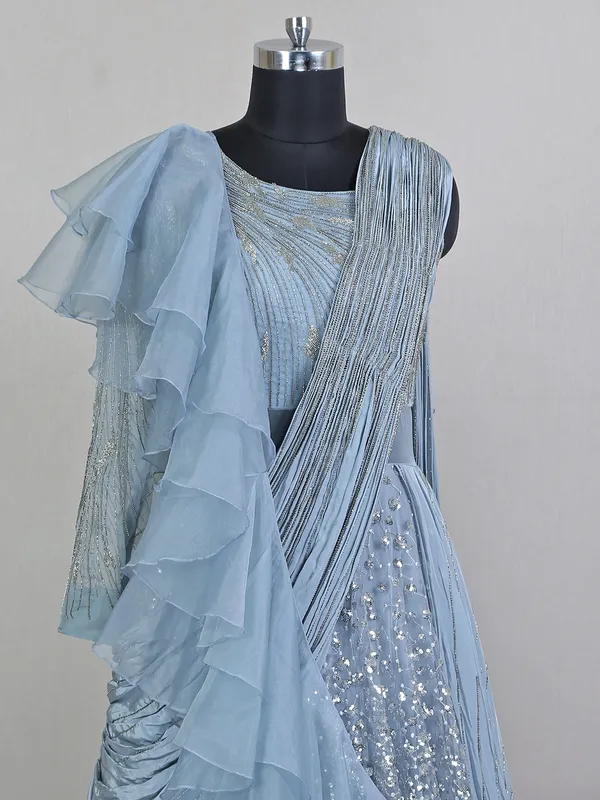 Blue net floor length gown with draped odhani pattern