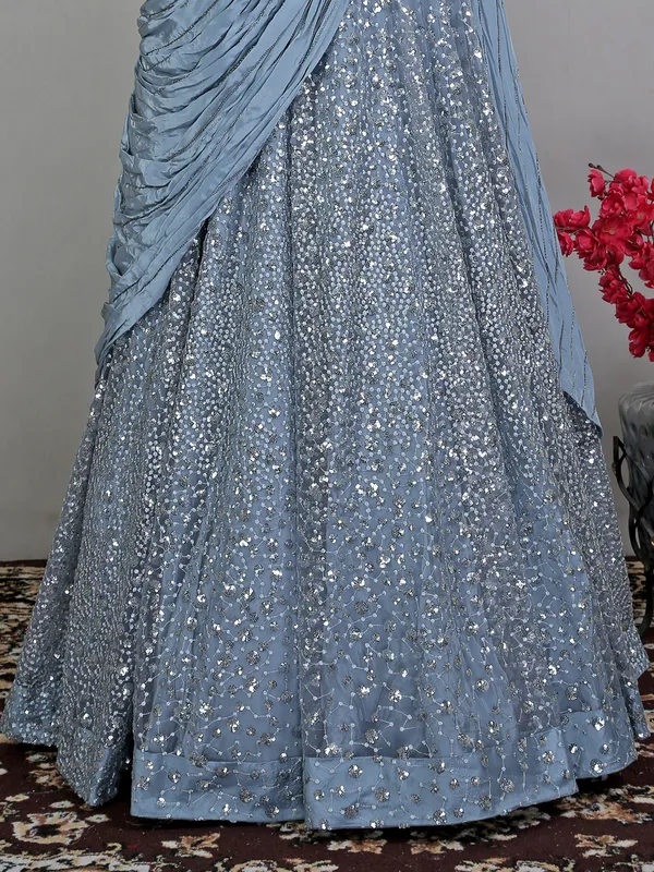 Blue net floor length gown with draped odhani pattern