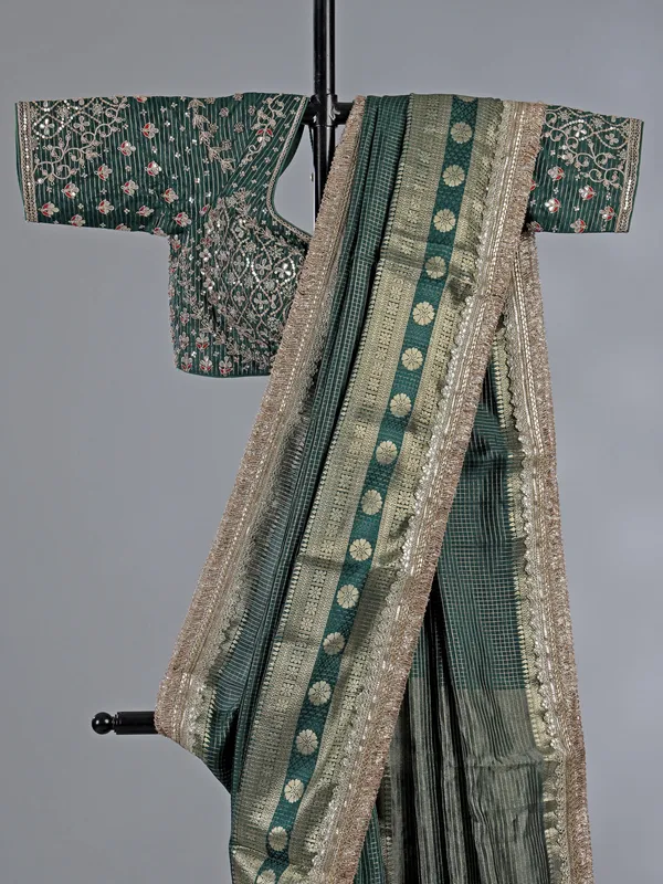 Bottle green dola silk saree with zari weaving