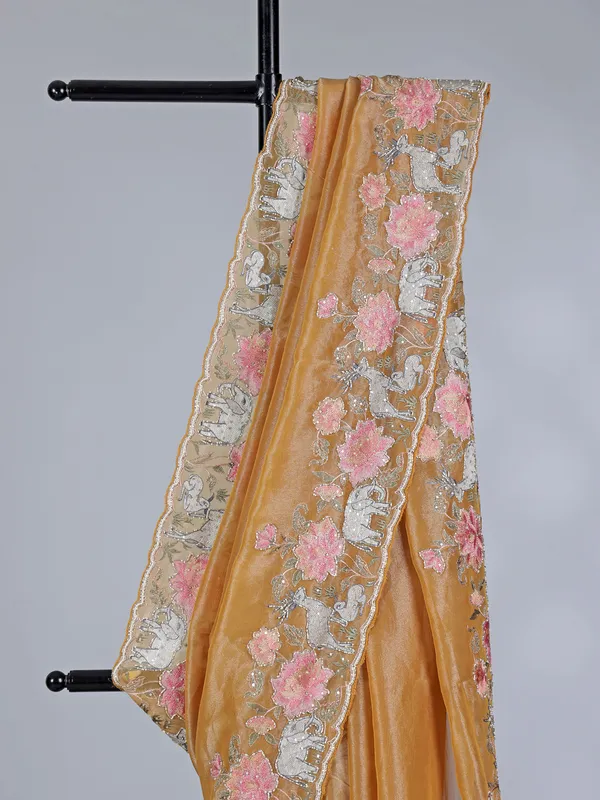 Brown tissue silk saree with elephant embroidered charm