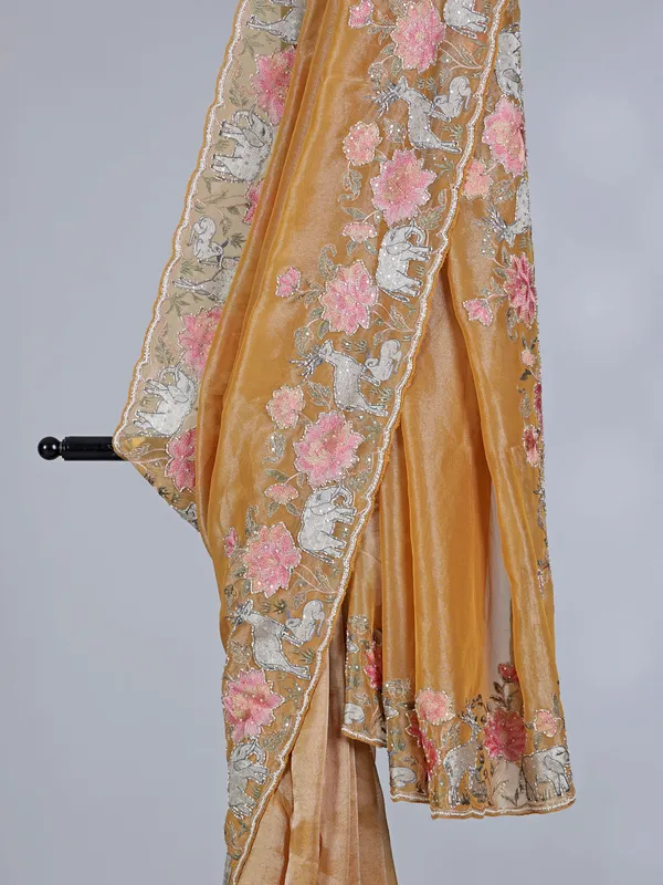 Brown tissue silk saree with elephant embroidered charm