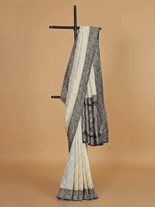 Cream and blue dola silk saree with zari weaving