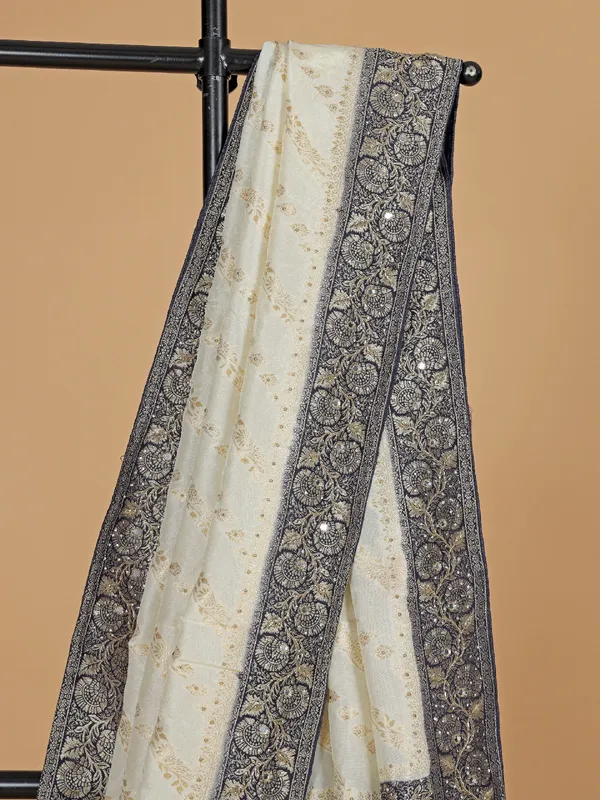 Cream and blue dola silk saree with zari weaving