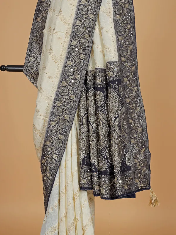 Cream and blue dola silk saree with zari weaving