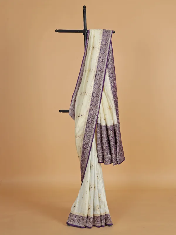 Cream and purple dola silk saree with zari work