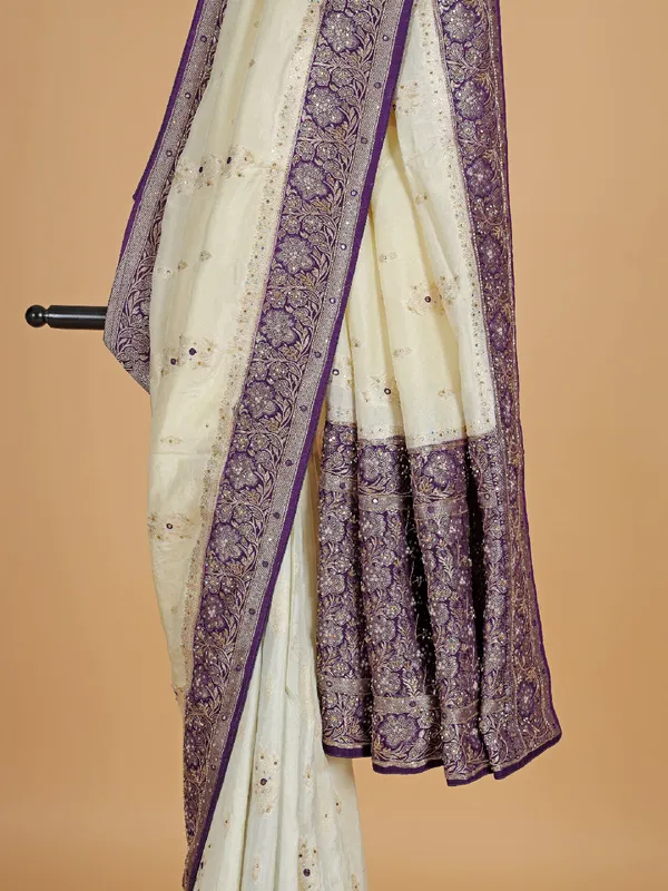 Cream and purple dola silk saree with zari work