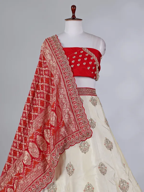 Cream and red silk lehenga choli with zardosi work
