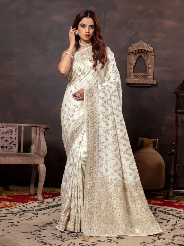 Cream dola silk saree with zari embellishment