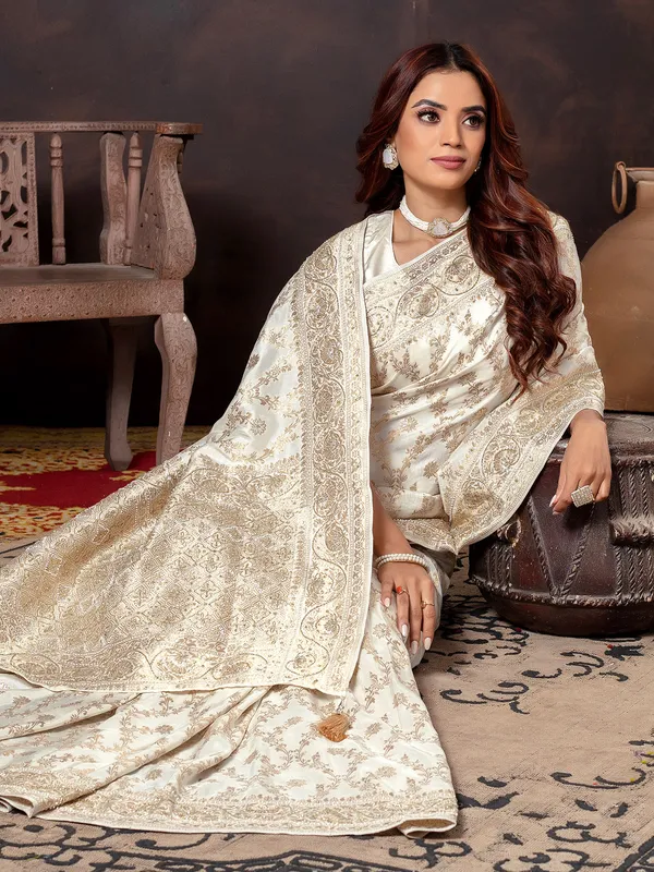 Cream dola silk saree with zari embellishment