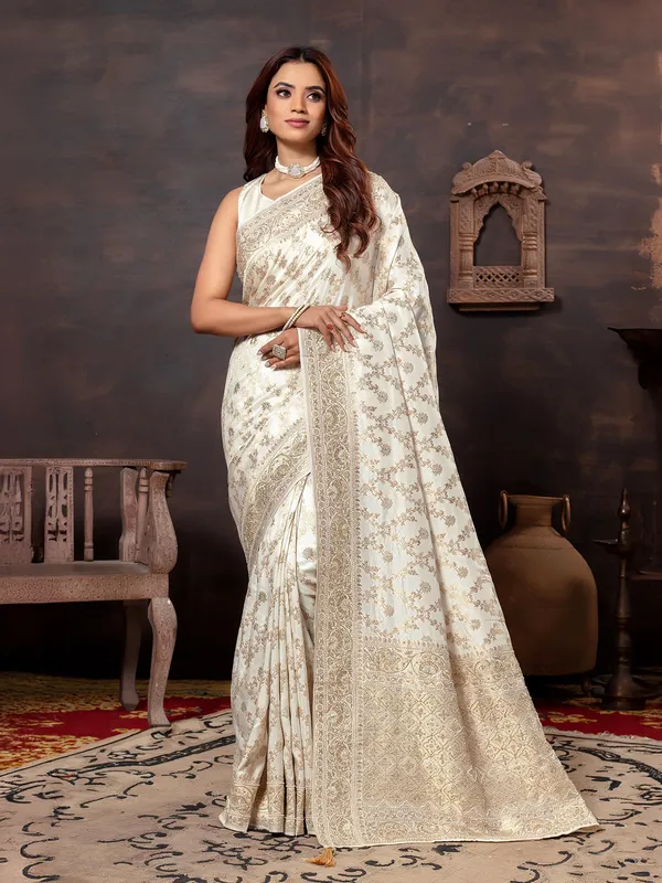 Cream dola silk saree with zari embellishment