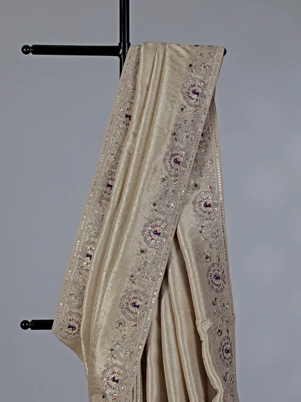 Cream embroidered tissue silk saree
