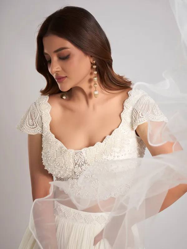 Cream georgette pearl lehenga choli with ruffle dupatta