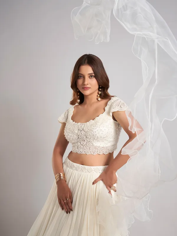 Cream georgette pearl lehenga choli with ruffle dupatta