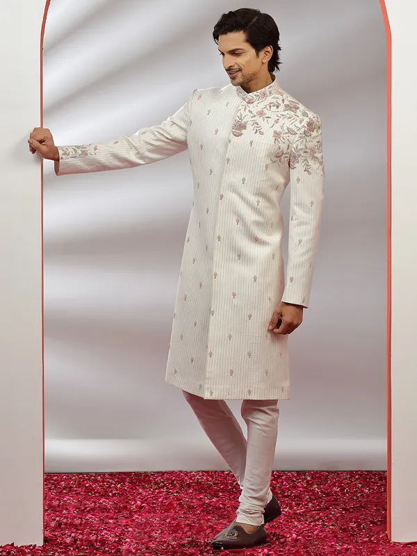 Cream hue raw silk groom wear sherwani