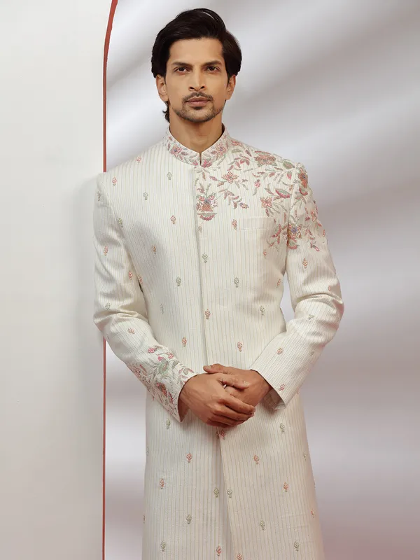 Cream hue raw silk groom wear sherwani