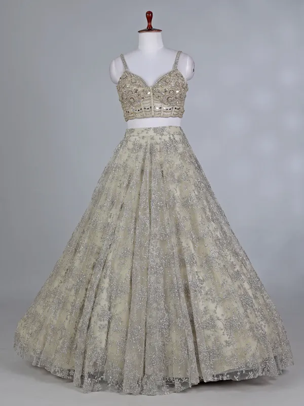 Cream net bridal lehenga choli with zardosi work