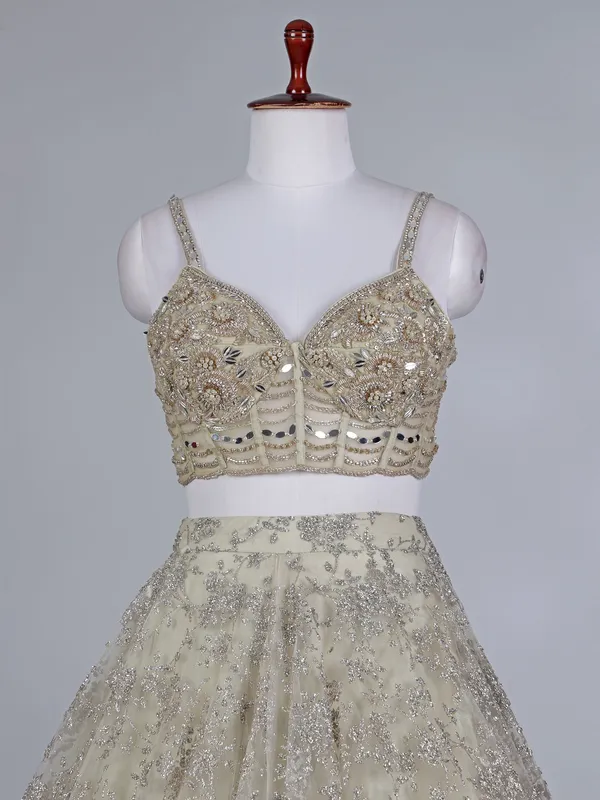 Cream net bridal lehenga choli with zardosi work