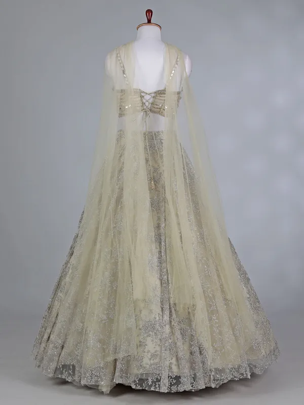 Cream net bridal lehenga choli with zardosi work
