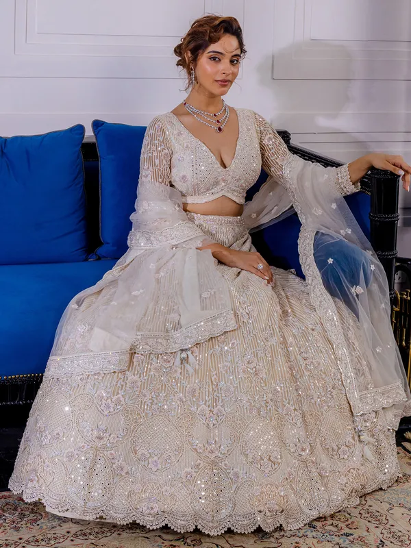 Cream net lehenga choli with thread work