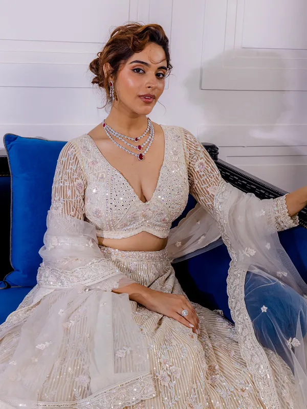 Cream net lehenga choli with thread work