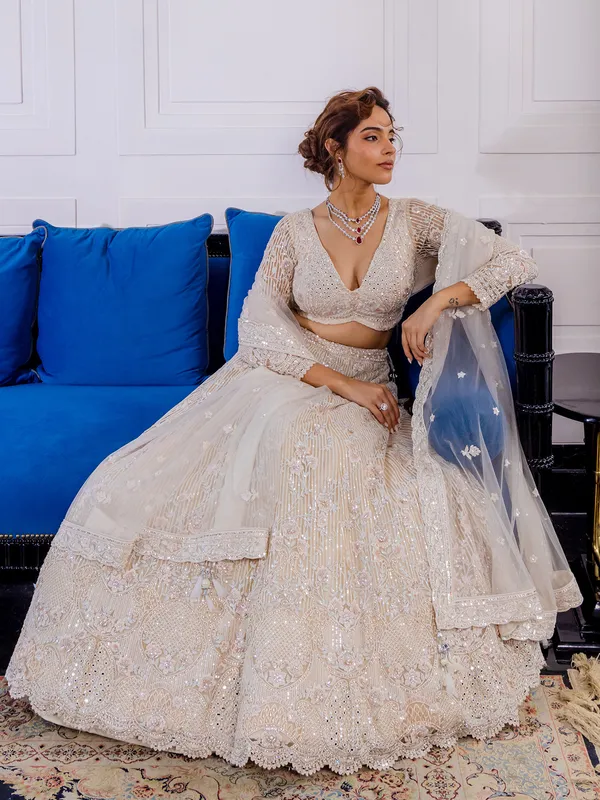 Cream net lehenga choli with thread work