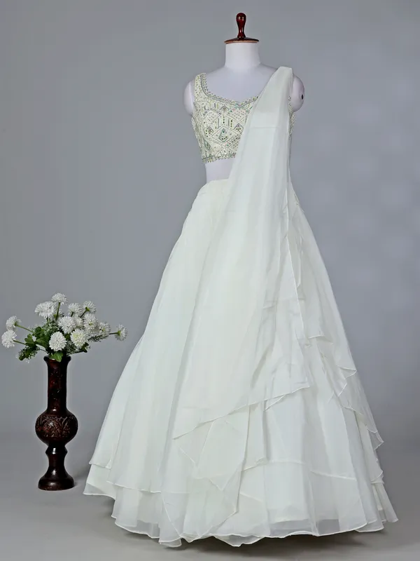 Cream organza sleeveless designer lehenga choli with dupatta