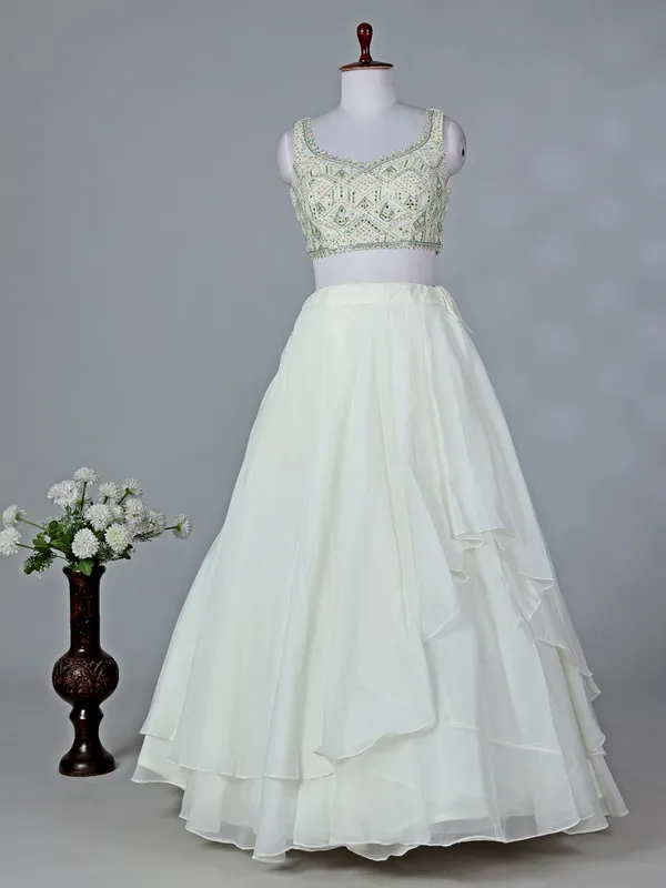 Cream organza sleeveless designer lehenga choli with dupatta