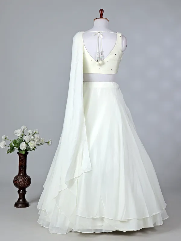 Cream organza sleeveless designer lehenga choli with dupatta