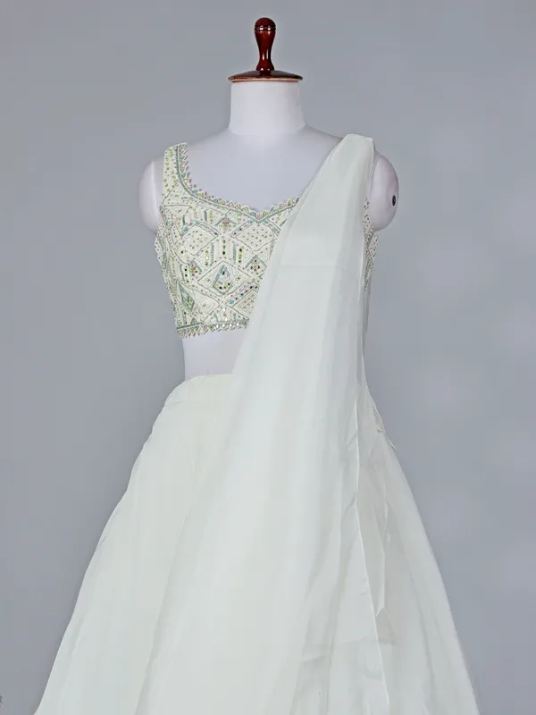 Cream organza sleeveless designer lehenga choli with dupatta