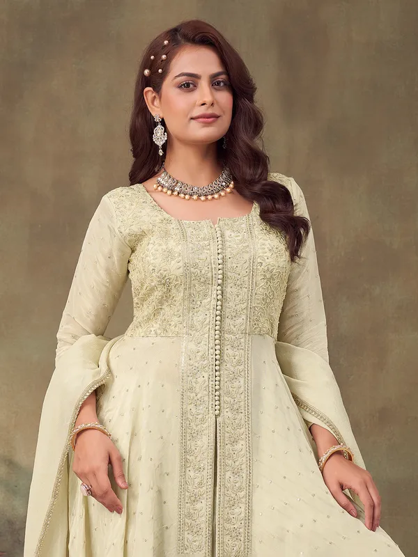 Cream pakistani silk suit with intricate embellishments for women
