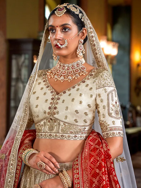 Cream silk bridal lehenga choli with red dupatta
