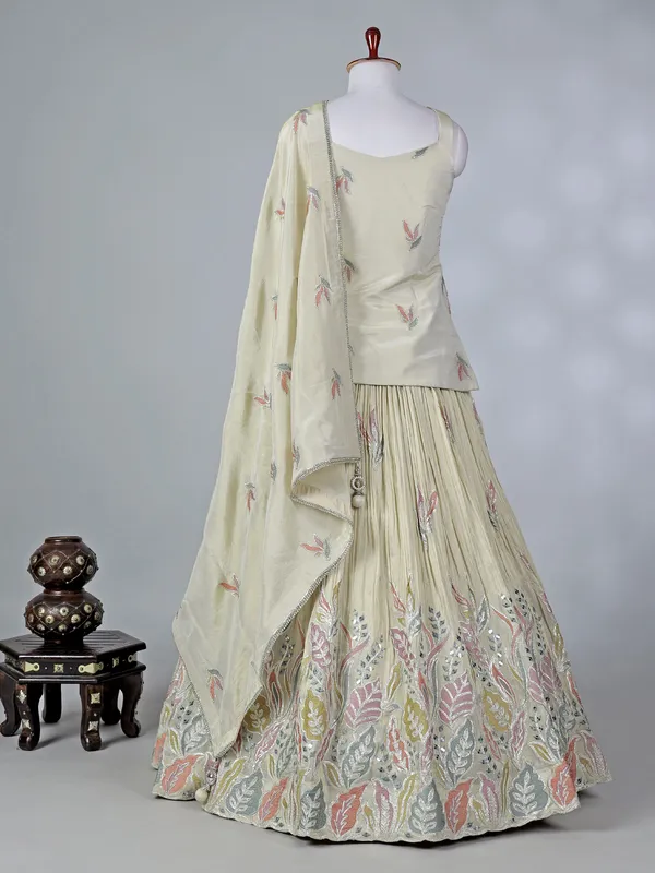 Cream silk lehenga choli with cowrie shells work