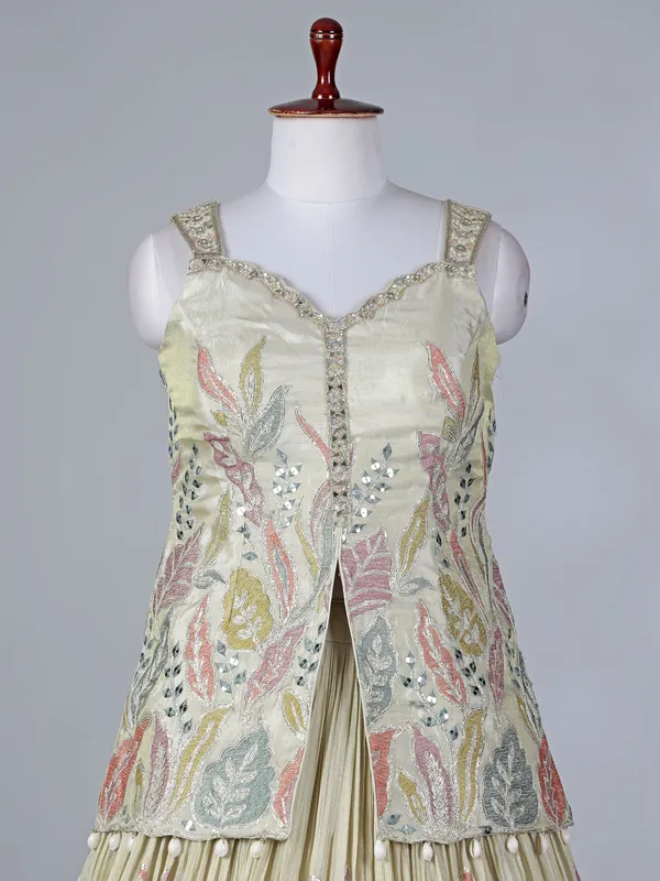 Cream silk lehenga choli with cowrie shells work