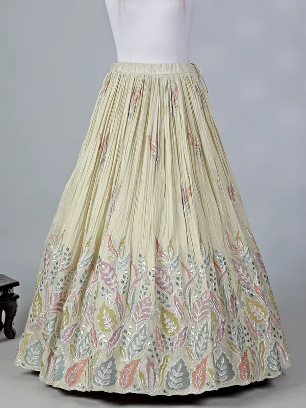 Cream silk lehenga choli with cowrie shells work