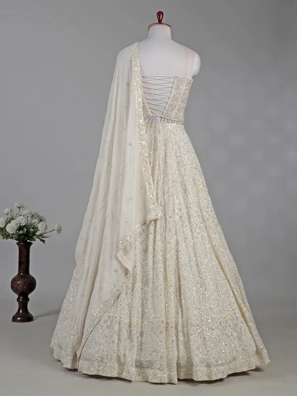 Cream silk lehenga choli with cutdana and sequins