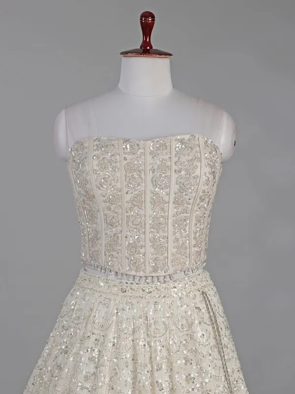 Cream silk lehenga choli with cutdana and sequins