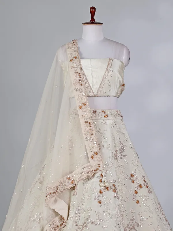 Cream silk lehenga choli with pearls and cutdana work