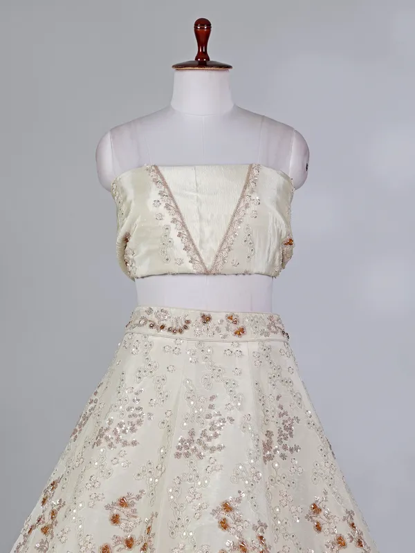 Cream silk lehenga choli with pearls and cutdana work