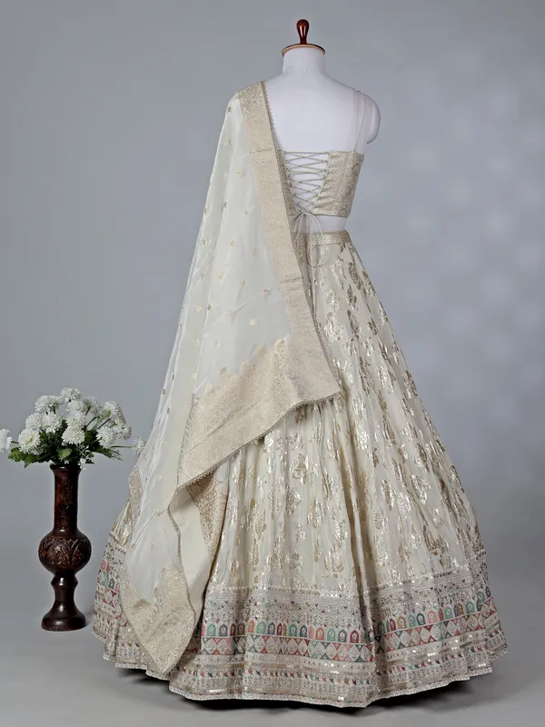Cream silk lehenga choli with sleeveless choli