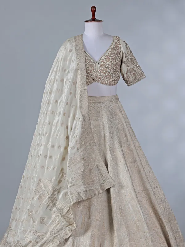 Cream silk lehenga with pearls and zari work