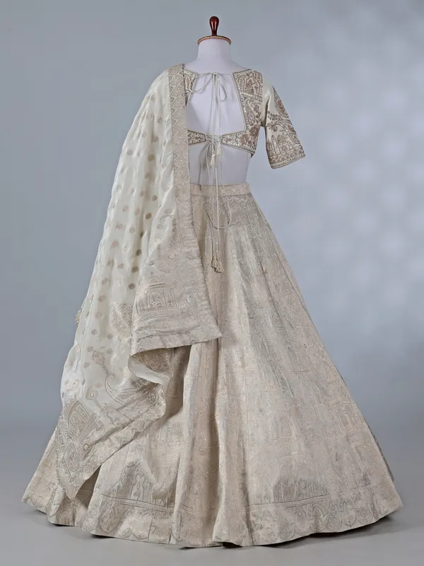 Cream silk lehenga with pearls and zari work