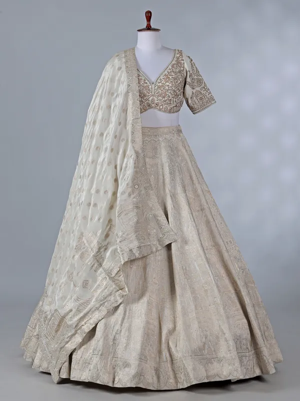 Cream silk lehenga with pearls and zari work