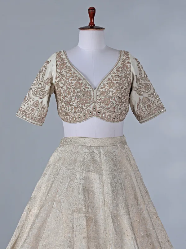 Cream silk lehenga with pearls and zari work