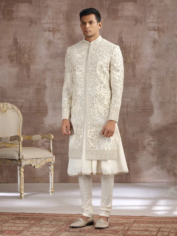 Cream silk peshwai sherwani with heavy embellishments