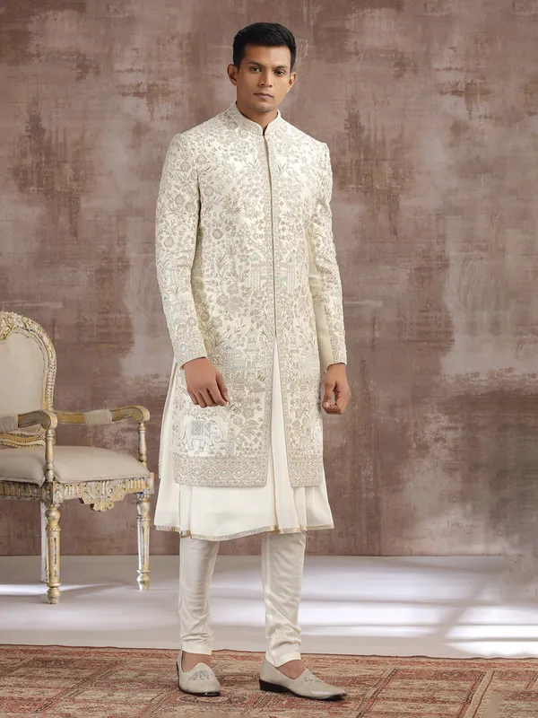Cream silk peshwai sherwani with heavy embellishments